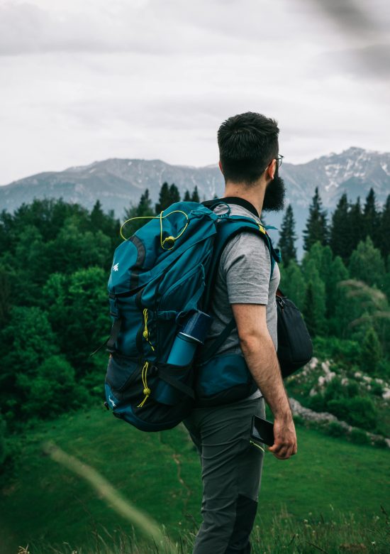 A male hiker explores lush Romanian mountain scenery, embodying adventure and exploration.